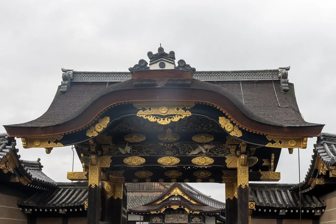The Kara-mon Gate of Nijo Castle, a black and gold gate with carved and gilded panels under a cypress-bark roof